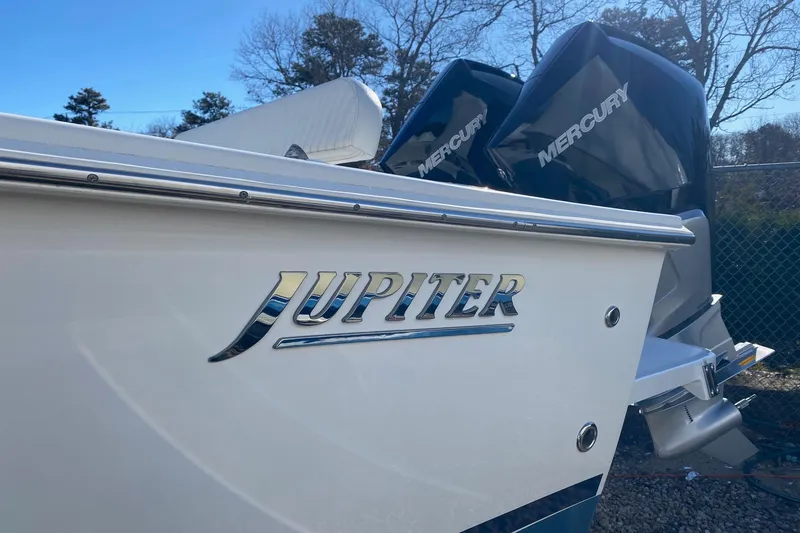 Slide: The Image of 2004 Jupiter 31 FS boat docked at marina under clear blue sky. - 16