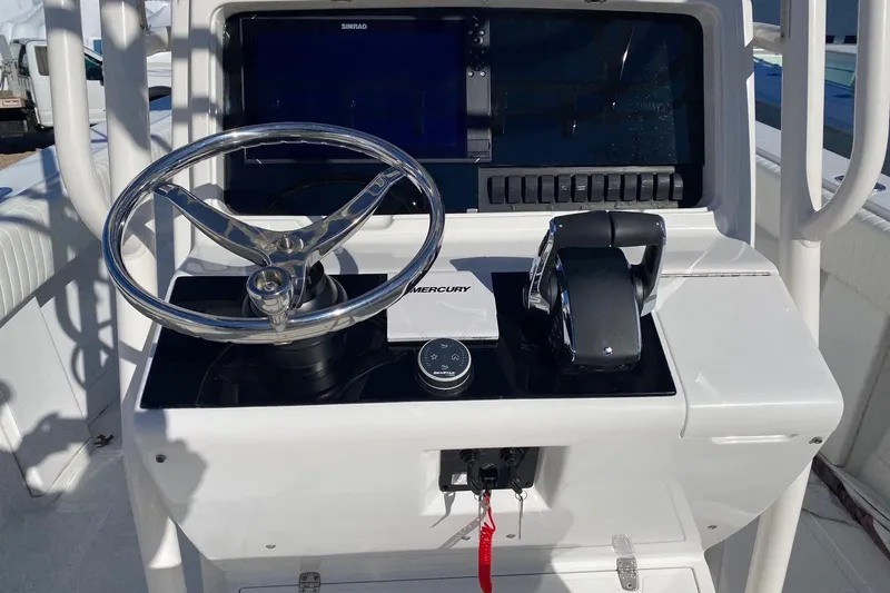 Slide: The Image of 2004 Jupiter 31 FS boat docked in a marina, featuring a spacious deck and helm station. - 17