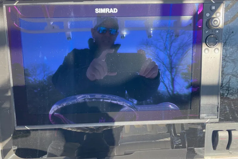 Slide: The Image of Twin outboard engines on a 2004 Jupiter 31 FS boat under clear blue sky. - 19