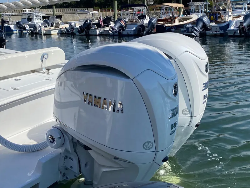 Slide: The Image of 2004 Jupiter 31 FS boat in a workshop with American flag and Mercury banners. - 4