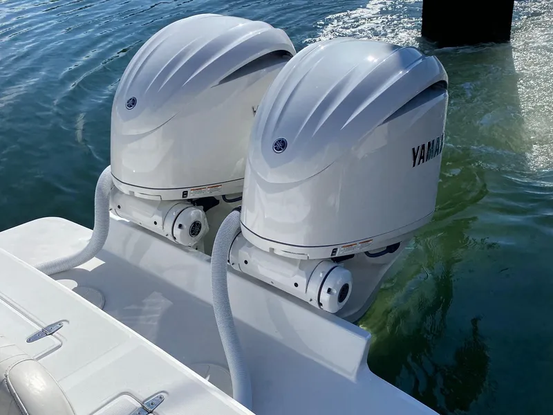 Slide: The Image of 2004 Jupiter 31 FS boat in a workshop, featuring a center console and T-top. - 5