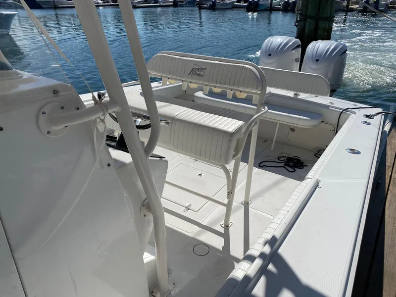 Slide: The Image of 2004 Jupiter 31 FS boat in a workshop, featuring a Mercury engine and American flag. - 6