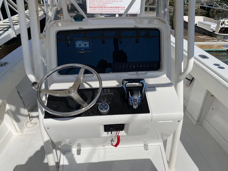 Slide: The Image of 2004 Jupiter 31 FS boat with Mercury engine in a garage setting. - 8