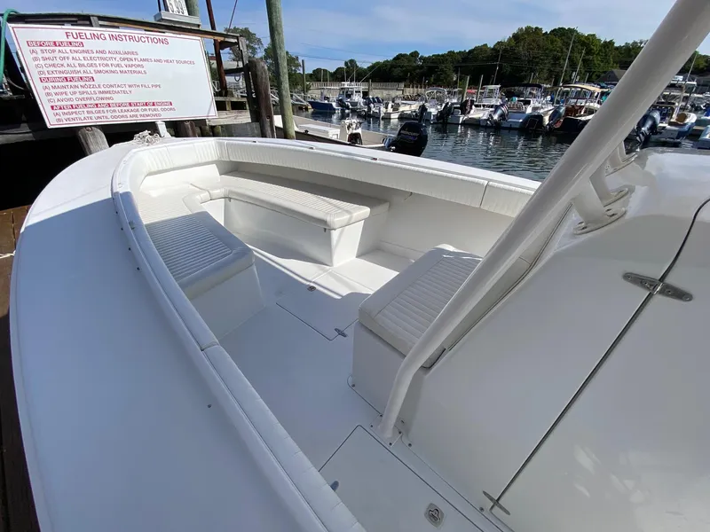 Slide: The Image of 2004 Jupiter 31 FS boat console with steering wheel and Mercury controls. - 9