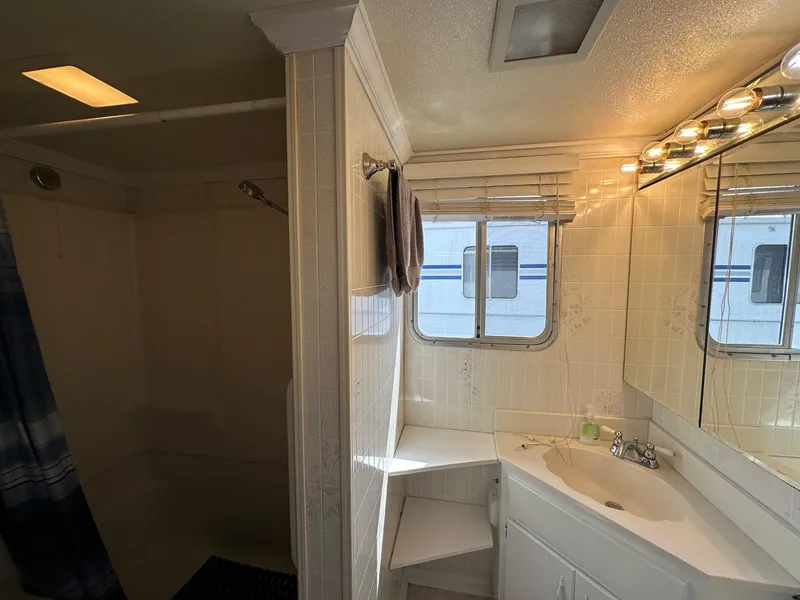 Slide: The Image of Bathroom interior of a 1985 Sumerset 14x60 houseboat with shower and vanity. - 10