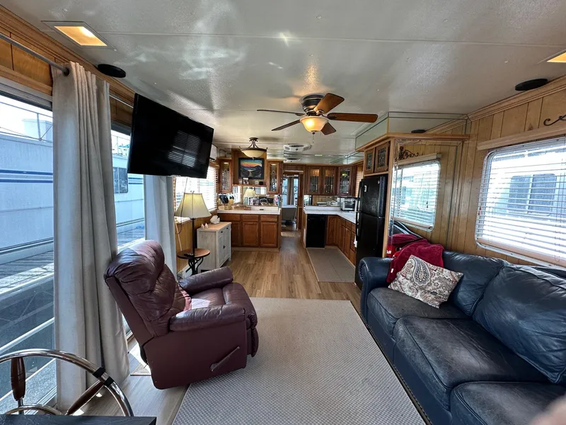 Slide: The Image of Interior of a 1985 Sumerset 14x60 houseboat with cozy living area and modern kitchen. - 2