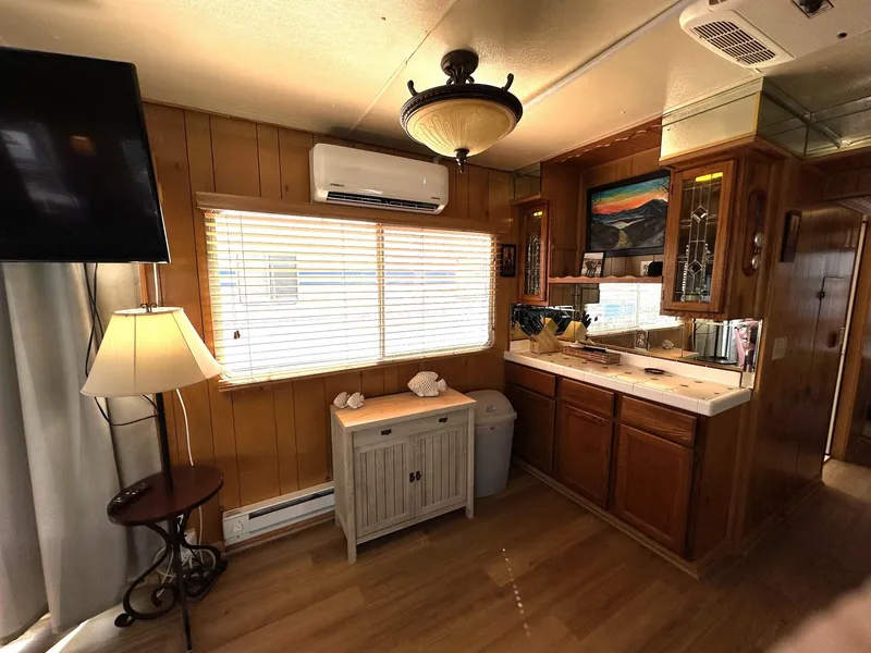Slide: The Image of Interior of a 1985 Sumerset 14x60 houseboat with wood paneling and modern amenities. - 5