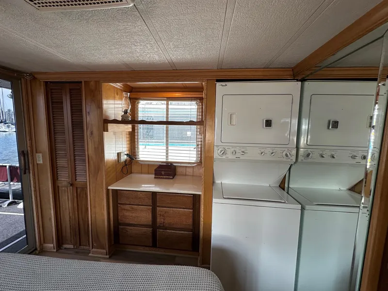 Slide: The Image of 1985 Sumerset 14x60 houseboat interior with laundry area and wooden cabinetry. - 7