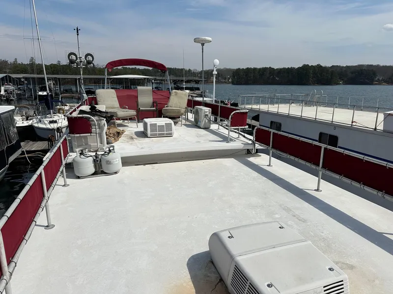 Slide: The Image of Rooftop deck of 1985 Sumerset 14x60 houseboat with seating and lake view. - 9