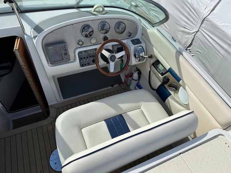 Slide: The Image of 2003 Chris-Craft 28' Corsair boat cockpit with steering wheel and control panel. - 16