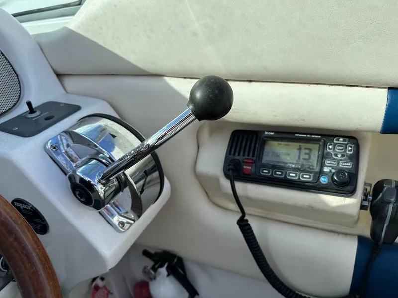 Slide: The Image of 2003 Chris-Craft 28' Corsair boat interior with throttle and marine radio. - 18