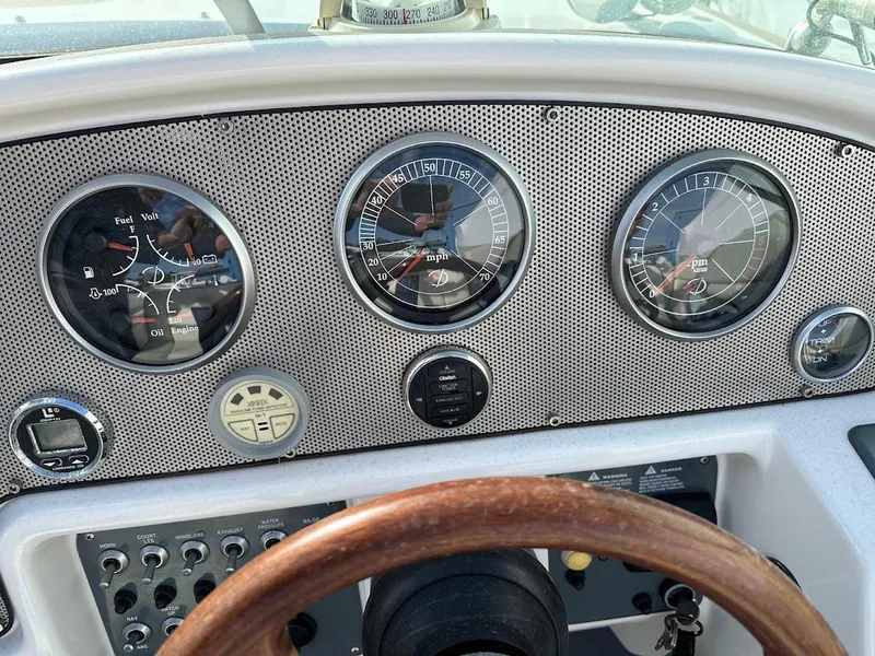 Slide: The Image of Dashboard of a 2003 Chris-Craft 28' Corsair boat with gauges and controls. - 21
