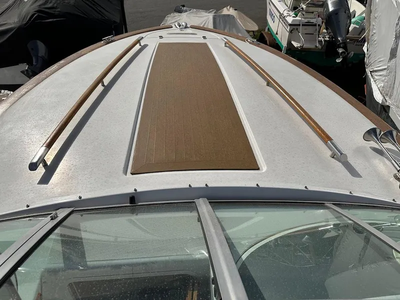 Slide: The Image of 2003 Chris-Craft 28' Corsair boat deck with wooden accents and sleek design. - 23