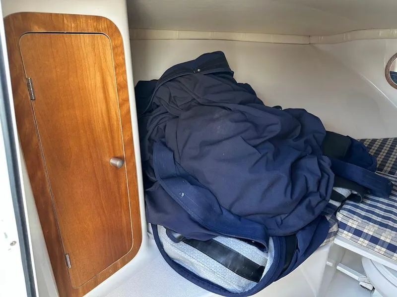 Slide: The Image of Interior cabin of 2003 Chris-Craft 28' Corsair with wooden cabinet and folded fabric. - 27