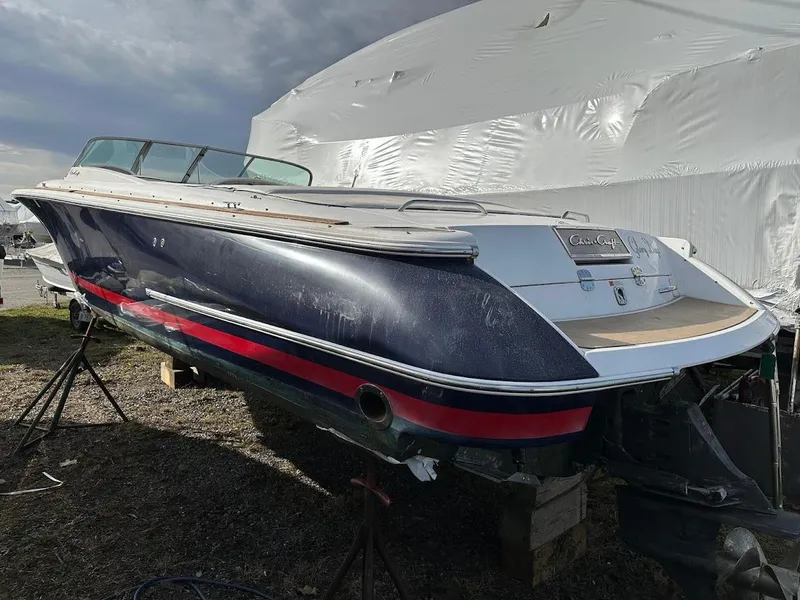 Slide: The Image of 2003 Chris-Craft 28' Corsair boat on stands, under a cloudy sky. - 3