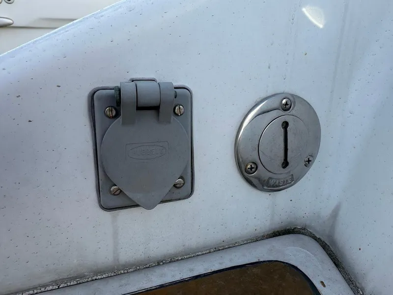 Slide: The Image of 2003 Chris-Craft 28' Corsair boat detail showing electrical outlet and keyhole. - 33