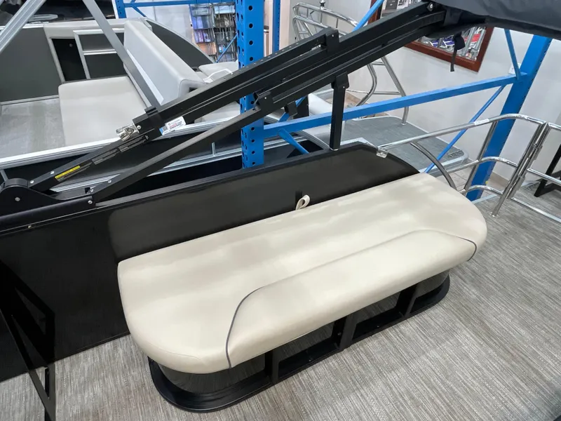 Slide: The Image of 2025 Godfrey SW2286SFLC Tritoon boat with beige seating and sleek design. - 13