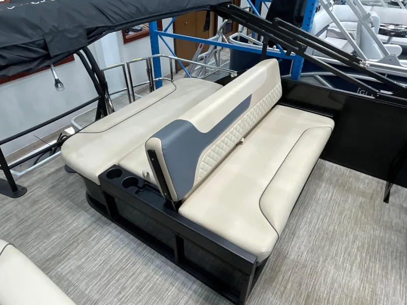 Slide: The Image of 2025 Godfrey SW2286SFLC Tritoon with beige seating and cup holders on deck. - 14