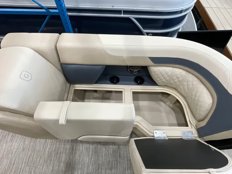 Slide: The Image of 2025 Godfrey SW2286SFLC Tritoon interior seating with storage compartments and cup holders. - 21