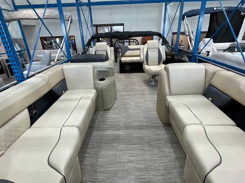 Slide: The Image of 2025 Godfrey SW2286SFLC Tritoon interior with beige seating and modern design. - 3