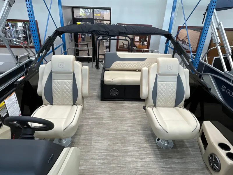 Slide: The Image of 2025 Godfrey SW2286SFLC Tritoon interior with luxurious seating and modern design. - 6