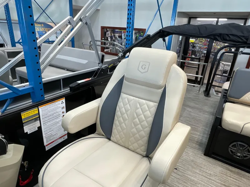 Slide: The Image of 2025 Godfrey SW2286SFLC Tritoon captain's chair with quilted design in showroom. - 9