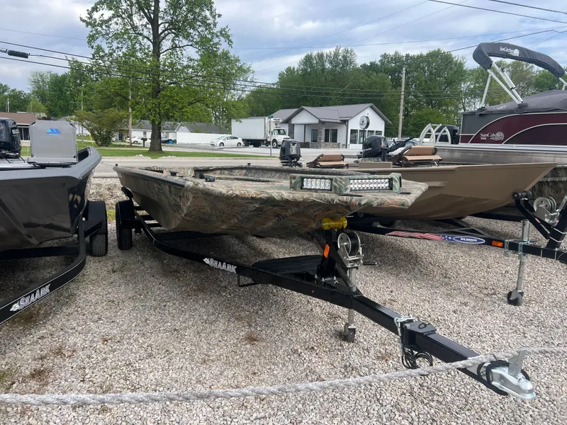 Slide: The Image of 2025 SeaArk 1960 Slayer Pro boat on trailer, parked outdoors on gravel. - 5