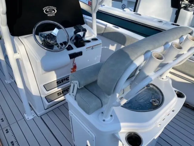 Slide: The Image of 2020 Sportsman Heritage 251 Center Console boat interior with steering wheel and seating. - 10