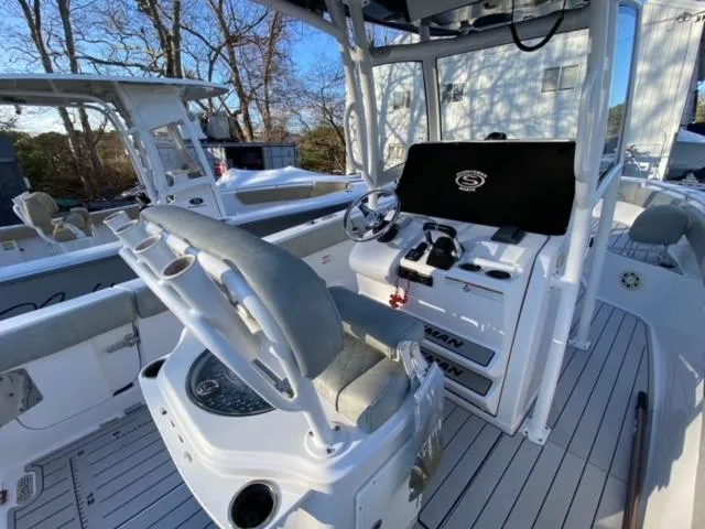 Slide: The Image of 2020 Sportsman Heritage 251 Center Console boat interior with steering wheel and seating. - 11