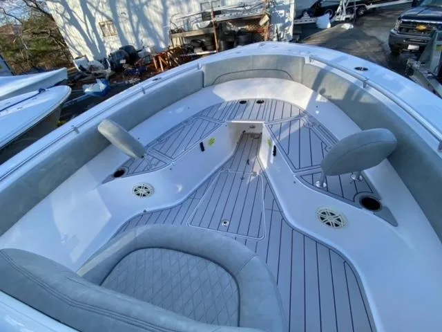 Slide: The Image of 2020 Sportsman Heritage 251 Center Console boat interior with seating and deck view. - 12