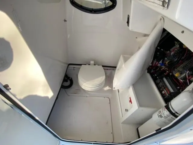 Slide: The Image of 2020 Sportsman Heritage 251 Center Console interior with toilet and storage compartments. - 14