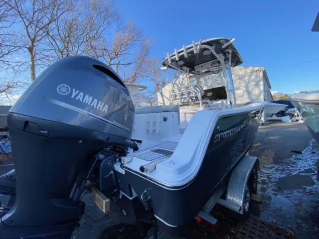 Slide: The Image of 2020 Sportsman Heritage 251 Center Console boat with Yamaha engine, parked outdoors. - 4