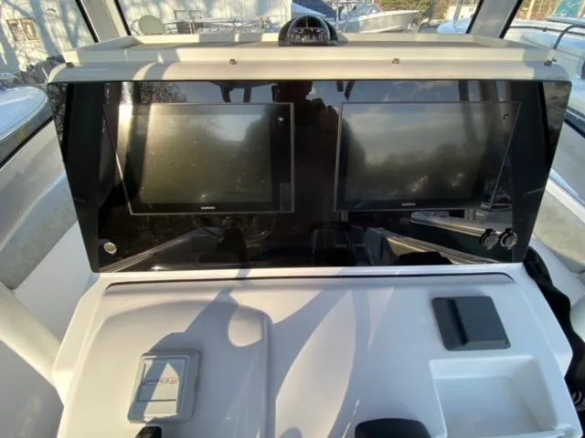 Slide: The Image of 2020 Sportsman Heritage 251 Center Console dashboard with dual screens and controls. - 7