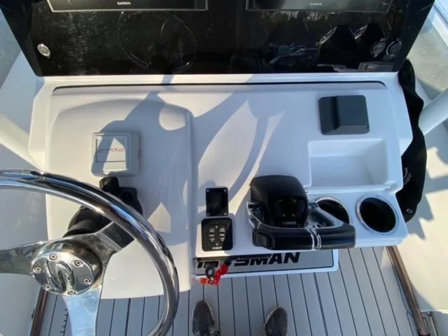 Slide: The Image of Center console of 2020 Sportsman Heritage 251 boat with steering wheel and controls. - 8