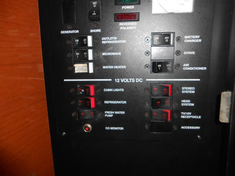 Slide: The Image of Control panel of a 2008 Sea Ray 260 Sundancer boat, featuring various switches and indicators. - 13