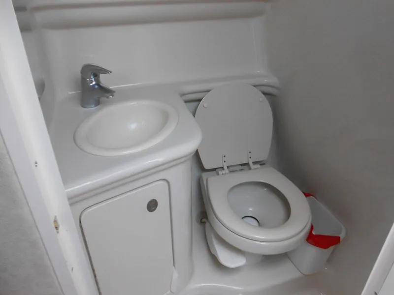 Slide: The Image of Compact bathroom in 2008 Sea Ray 260 Sundancer boat with sink and toilet. - 14