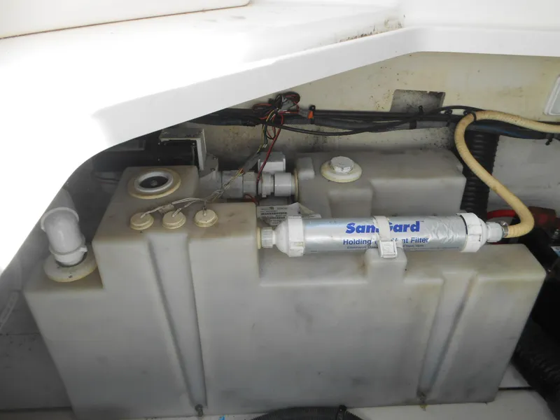 Slide: The Image of 2008 Sea Ray 260 Sundancer water tank and filtration system in boat compartment. - 18