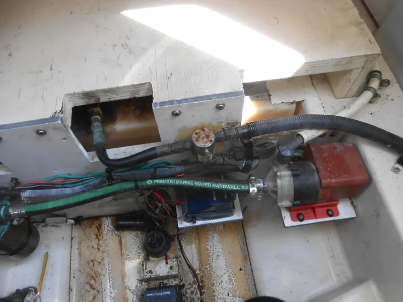 Slide: The Image of Engine compartment of a 2008 Sea Ray 260 Sundancer, showing hoses and mechanical components. - 23