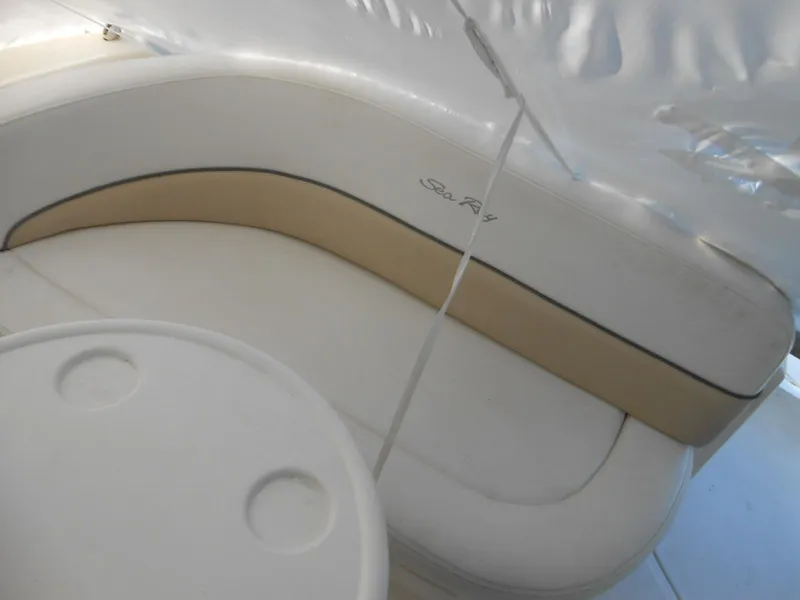 Slide: The Image of 2008 Sea Ray 260 Sundancer boat interior with curved seating and table. - 3