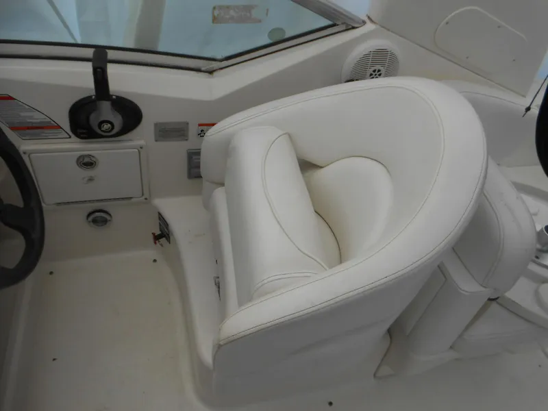 Slide: The Image of 2008 Sea Ray 260 Sundancer cockpit with white leather seating and control panel. - 4