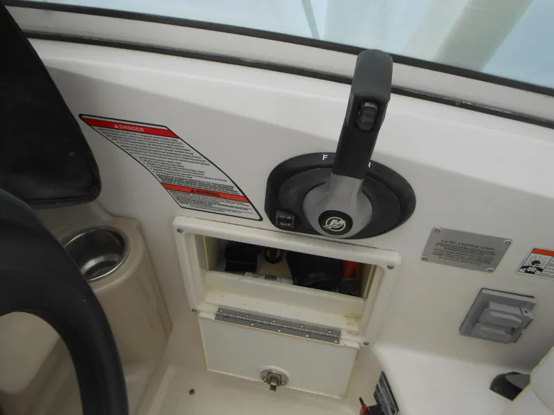 Slide: The Image of Control panel of 2008 Sea Ray 260 Sundancer boat with throttle lever and warning labels. - 5
