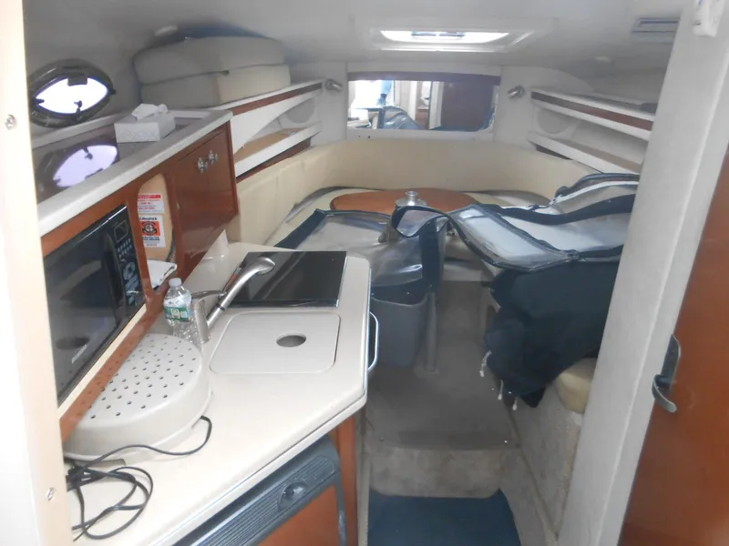 Slide: The Image of Interior of 2008 Sea Ray 260 Sundancer boat with kitchenette and seating area. - 8