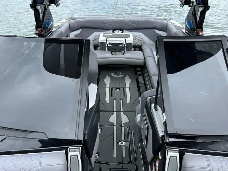 Slide: The Image of 2025 Centurion Ri245 boat interior with sleek seating and modern design on the water. - 10