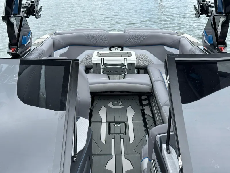 Slide: The Image of 2025 Centurion Ri245 boat interior with sleek seating and modern design on the water. - 11