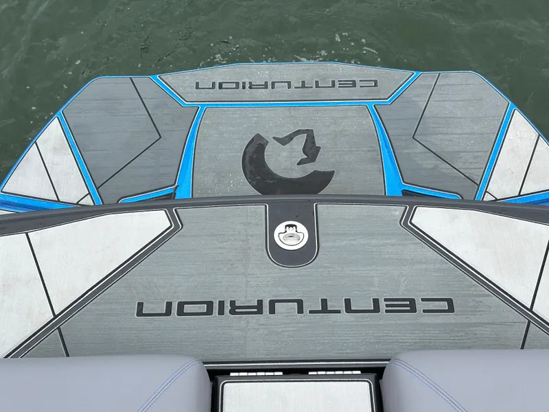 Slide: The Image of 2025 Centurion Ri245 boat deck with logo, featuring sleek design and blue accents. - 13