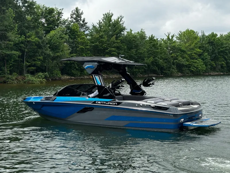 Slide: The Image of 2025 Centurion Ri245 boat on a lake, featuring sleek design and vibrant blue accents. - 3