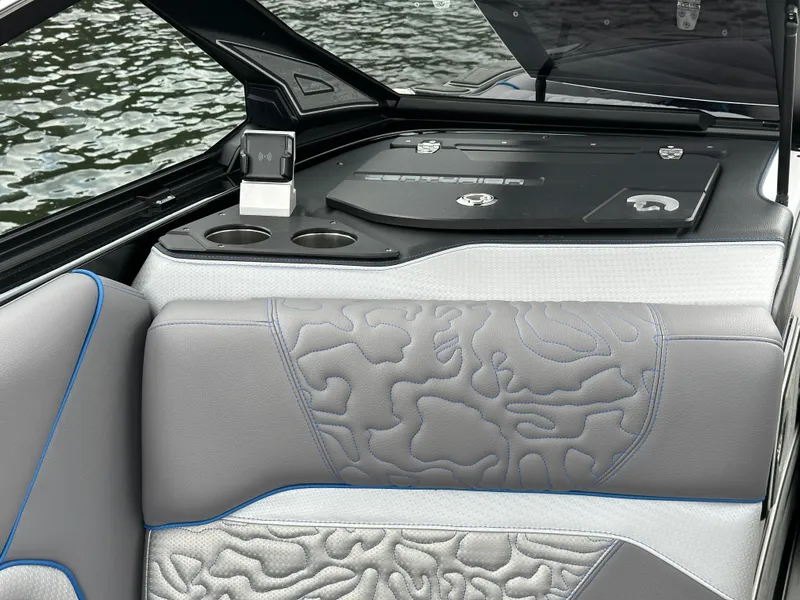 Slide: The Image of 2025 Centurion Ri245 boat interior with stylish gray seating and cup holders. - 8