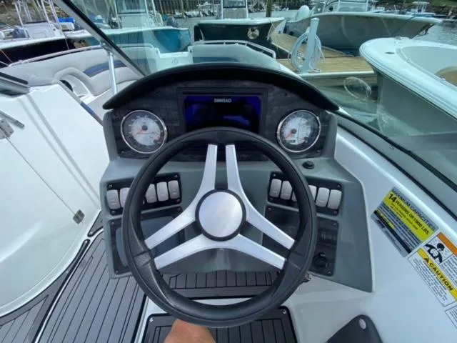 Slide: The Image of 2018 Hurricane SunDeck 2486 OB boat dashboard with steering wheel and gauges. - 4