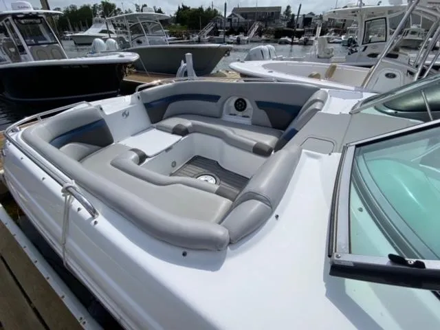 Slide: The Image of 2018 Hurricane SunDeck 2486 OB boat with spacious seating at a marina. - 5