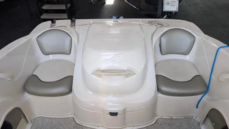 Slide: The Image of 2005 Sea Ray 180 Sport boat interior with dual seating and storage compartment. - 11